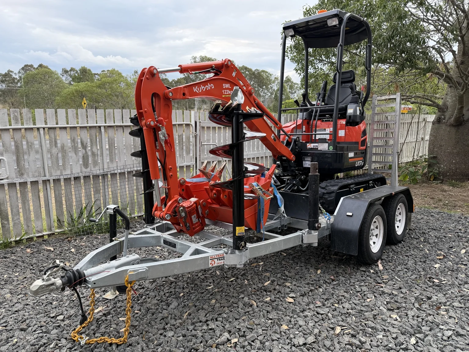 HG Hire Kubota U17 mini excavator with augers and buckets on its plant trailer